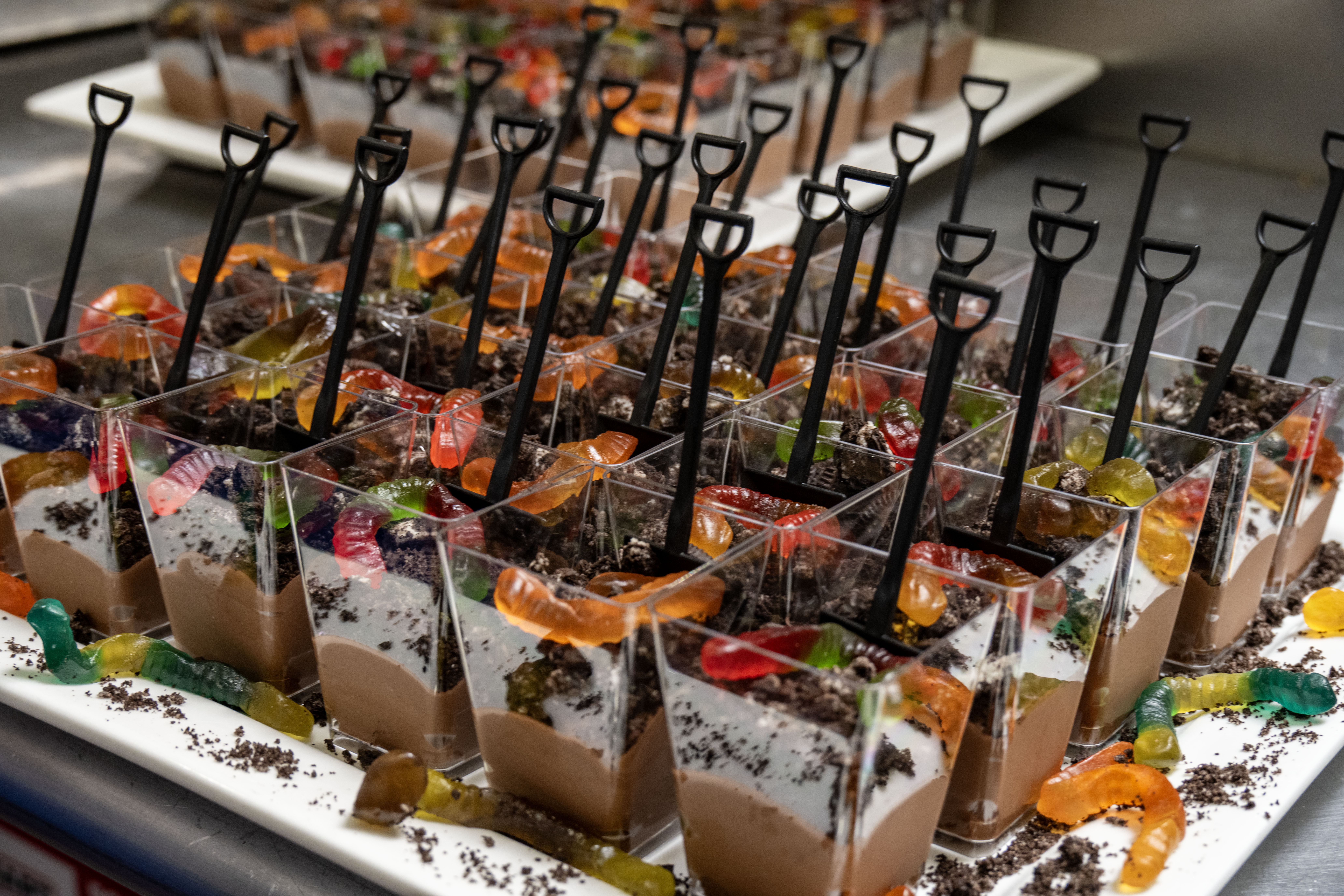 A few cups of the classic sweet dirt cups with chocolate mousse, cookie crumbles and gummy worms